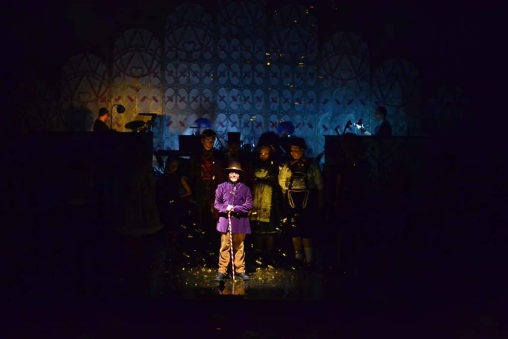 Willie Wonka production in Dubai, UAE with Wonka stood centre stage with a single spotlight on him.